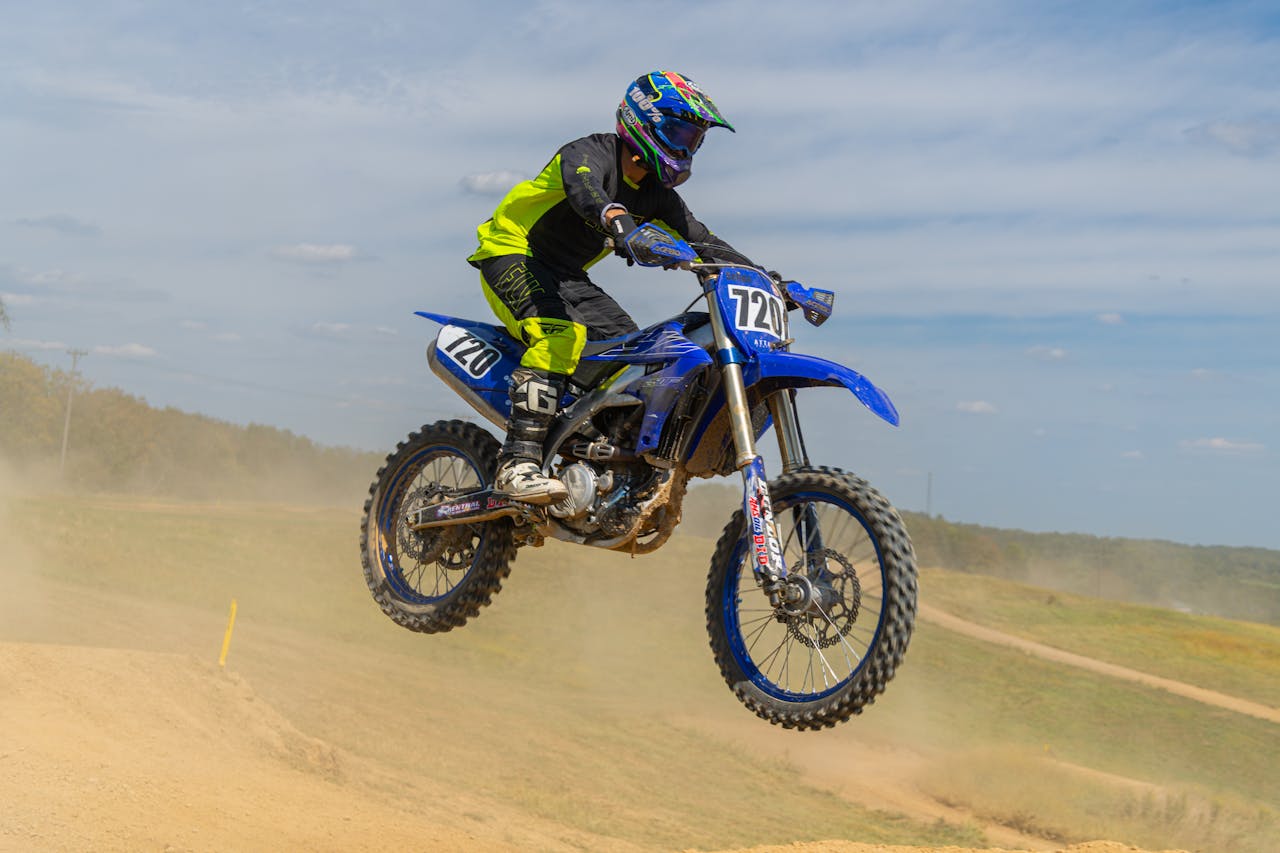 motocross-rider-jumping-mid-air-on-dirt-track-33896135